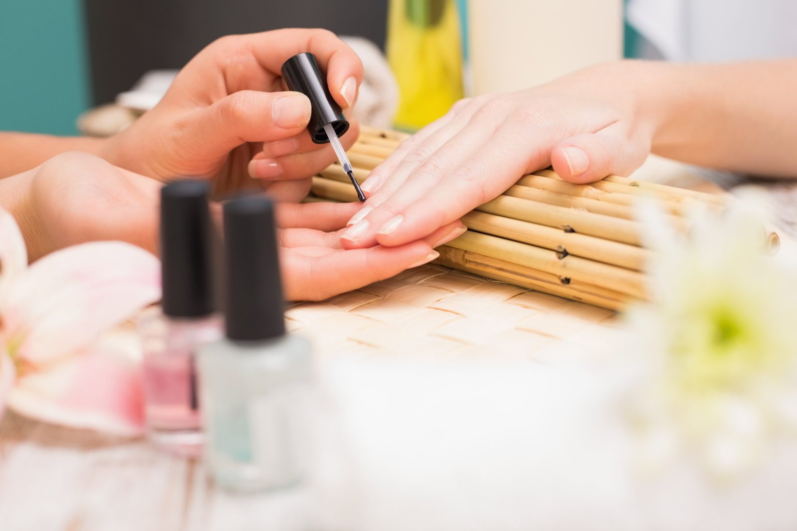 Nail technician giving customer a manicure at the beauty salon